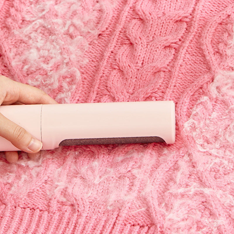 Fresh Sweep fabric hair-removal brush shown across a pink knitted textile