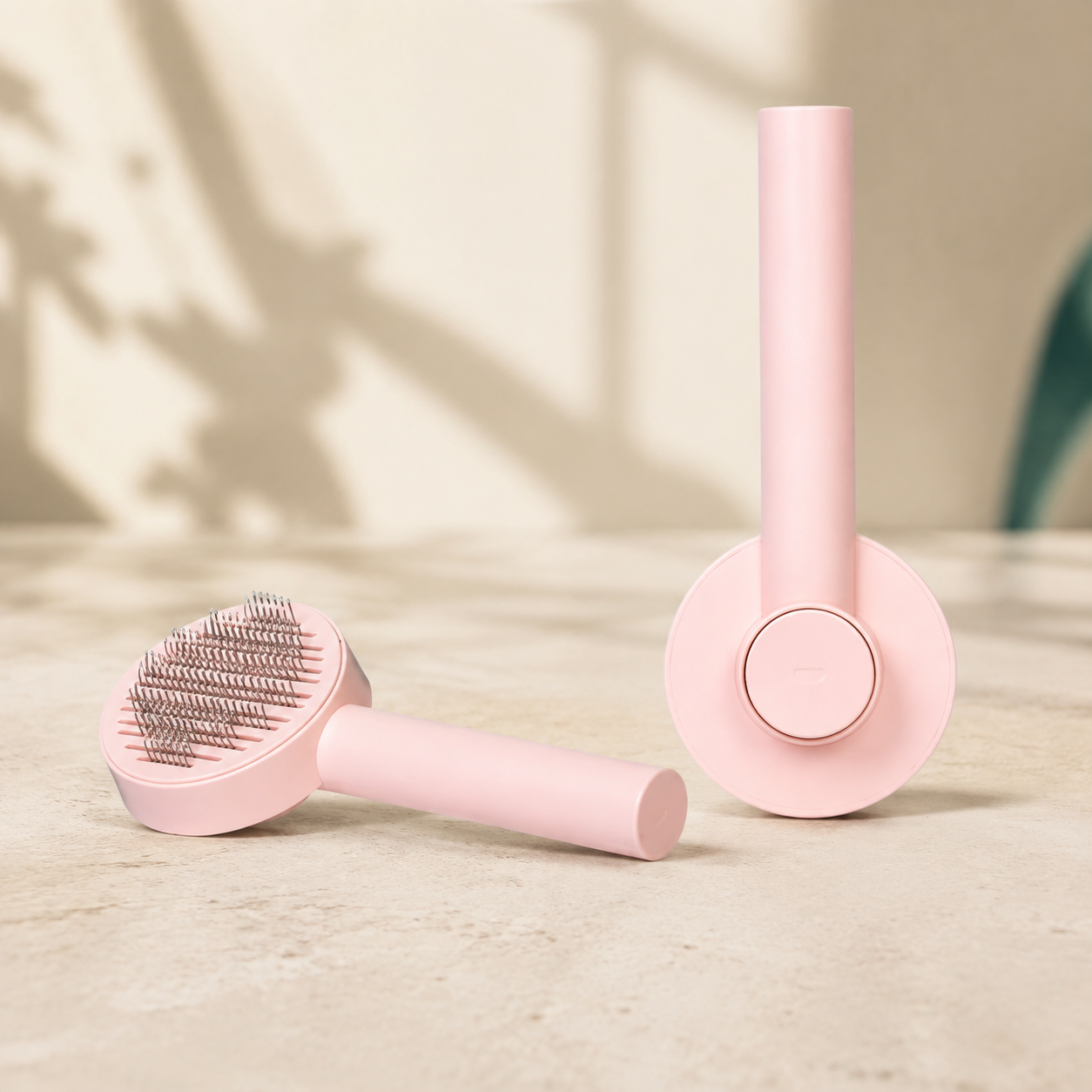 Everyday Ease pink grooming brush, front and back views in a styled studio setting; one brush included
